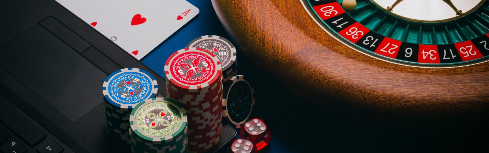 Close-up of a roulette table, poker chips, and playing cards depicting casino culture.